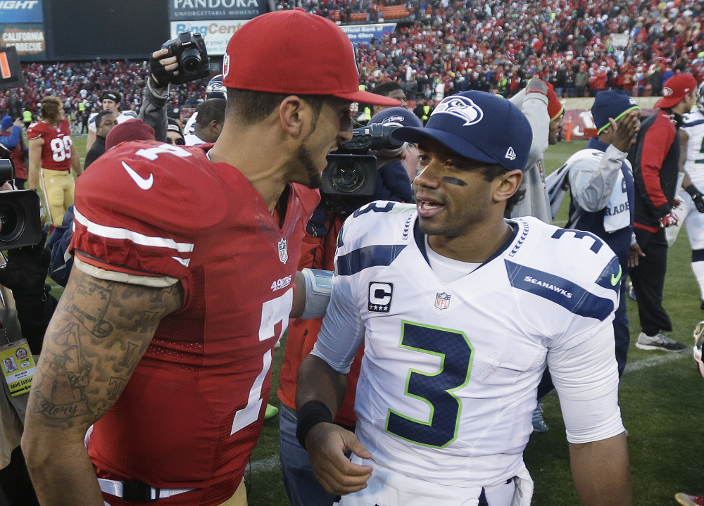 49ers quarterback Colin Kaepernick, left, meets with Seahawks quarterback Russell Wilson after a Dec. 8 game in San Francisco. They will meet again Sunday in the NFC championship game in Seattle.