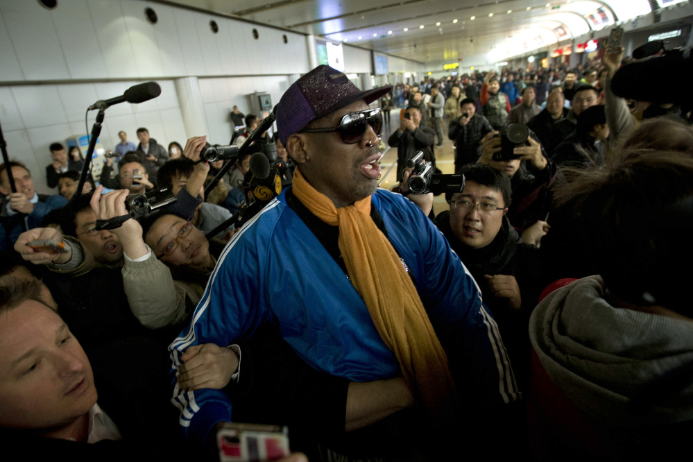 Dennis Rodman is followed by journalists as he arrives at the Capital International Airport in Beijing from Pyongyang, Monday.