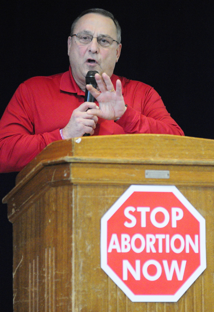 COUNT HIM IN: Gov. Paul LePage speaks at rally Saturday in the St. Michael School gymnasium before the Hands Around the Capitol Memorial in Augusta. LePage and other speakers talked at the rally, held to mark the 41st anniversary of the Supreme Court’s Roe v. Wade decision, before people left the gymnasium to hold hands around the nearby State House.