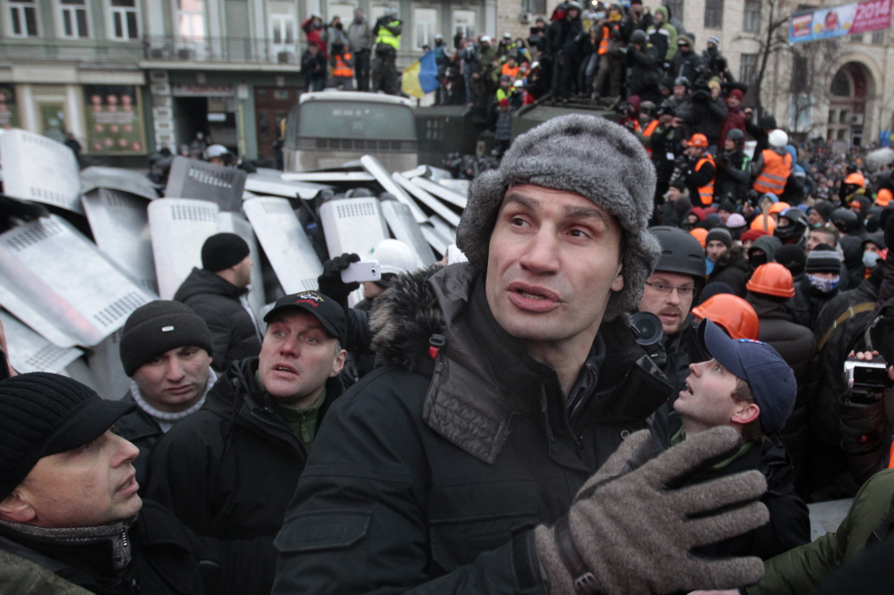 Opposition leader and former WBC heavyweight boxing champion Vitali Klitschko tries to stop the fighting between opposition protesters and riot police in Kiev, Ukraine, Sunday.
