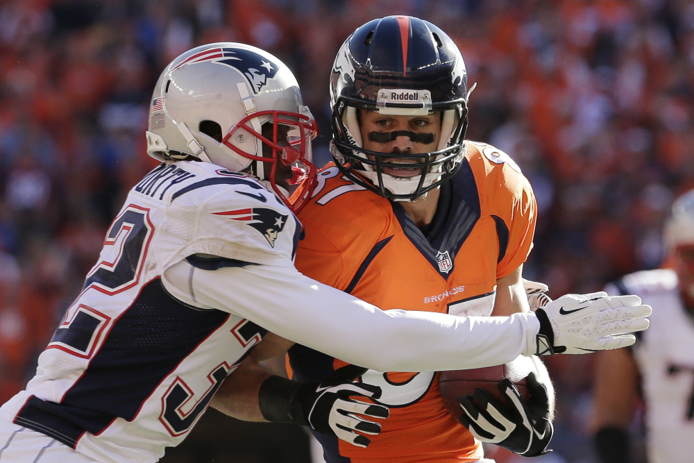Patriots free safety Devin McCourty wraps up Denver wide receiver Eric Decker in the first half Sunday in the AFC championship game at Denver.