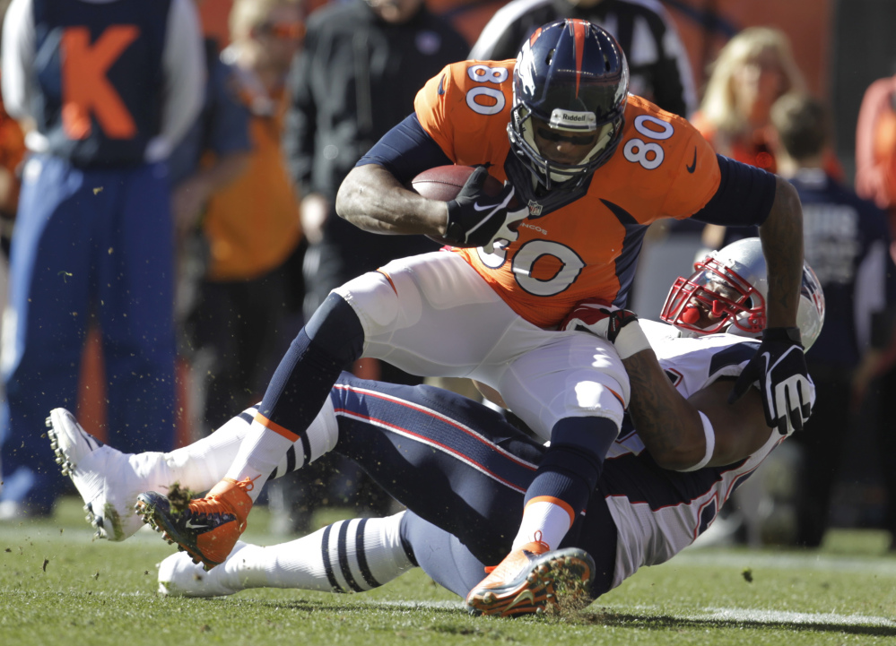 Broncos tight end Julius Thomas is stopped by Patriots outside linebacker Dont’a Hightower in the first half Sunday at Denver.