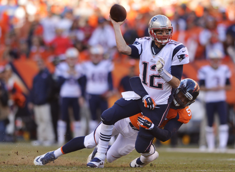 New England Patriots quarterback Tom Brady (12) is hauled to the turf by Denver Broncos defensive end Jeremy Mincey (57) during the second half of the AFC Championship NFL playoff football game in Denver, Sunday, Jan. 19, 2014. (AP Photo/Jack Dempsey)