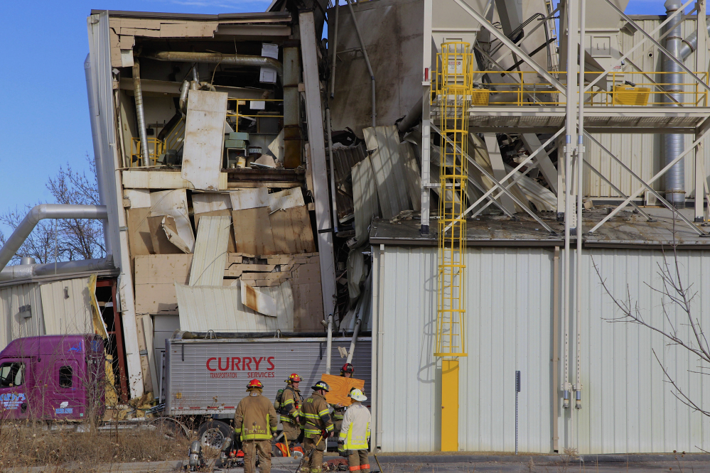 Firefighters stage operations outside the International Nutrition plant in Omaha, Neb., Monday, where 38 people were working when there was an explosion and fire there.