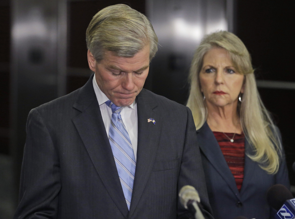 Former Virginia Gov. Bob McDonnell pauses while making a statement as his wife, Maureen, right, listens during a news conference in Richmond, Va., Tuesday, Jan. 21, 2014. McDonnell and his wife were indicted Tuesday on corruption charges after a monthslong federal investigation into gifts the Republican received from a political donor.