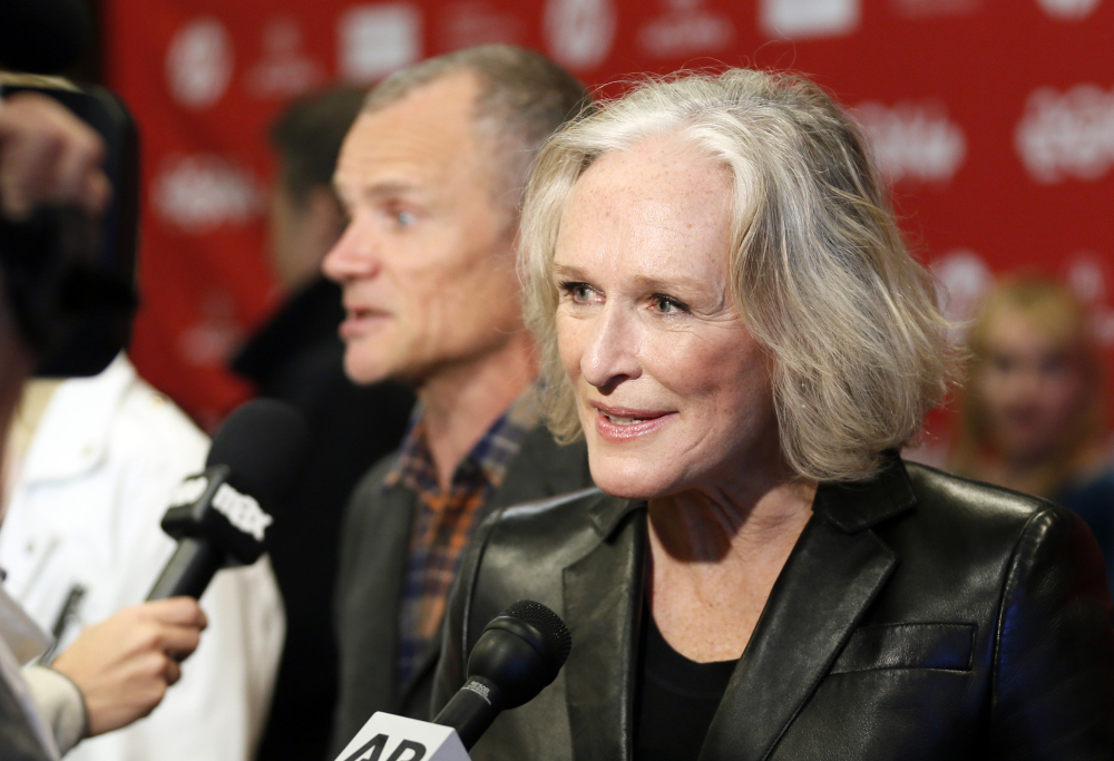 “Low Down” cast member Glenn Close speaks with reporters as fellow cast member Flea, rear, of the Red Hot Chili Peppers, is also interviewed at the premiere of the film Sunday at the 2014 Sundance Film Festival, in Park City, Utah.