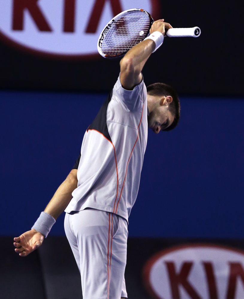 Novak Djokovic of Serbia reacts after losing a point during his quarterfinal against Stanislas Wawrinka of Switzerland at the Australian Open tennis championship in Melbourne, Australia, Tuesday, Jan. 21, 2014.(AP Photo/Aaron Favila)