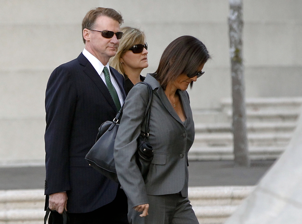 Former Deutsche Bank executive Brian Mulligan arrives with his wife Victoria, center, at the Edward R. Roybal Federal Building in Los Angeles on Tuesday, to pursue an excessive force suit against two Los Angeles police officers. A civilian oversight board found the officers’ use of force appropriate.