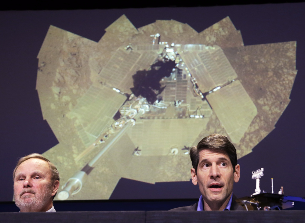 Mars rovers project manager John Callas, right, and investigator Ray Arvidson attend an event Thursday marking the 10th anniversary of the NASA Mars Opportunity rover mission. Projected at rear is what Callas described as a “selfie,” a self-portrait of the rover’s solar panels.