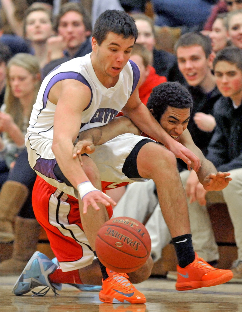 Staff photo by Michael G. Seamans Waterville Senior High School's Christopher Hale, 21, fights for the loose ball with Camden Hills High School's Colin Morse, 23, in the fourth quarter in Waterville on Friday. Waterville defeated Camden Hills 62-56.