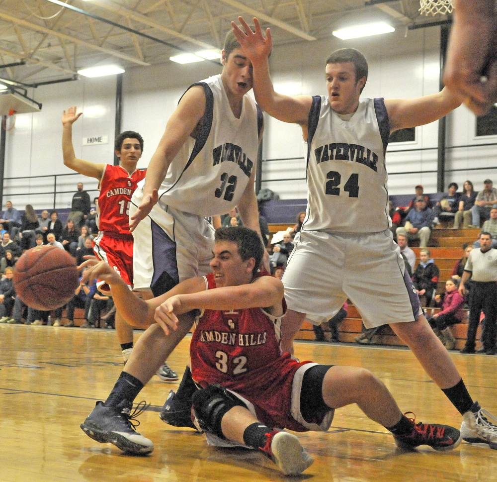 Staff photo by Michael G. Seamans Camden Hills High School's Jayson Kuhn, 32, tries to pas the ball as he is defended by Waterville Senior High School's Owen Brown, 32, and Matthew Bernier, 24, in the second quarter in Waterville on Friday. Waterville defeated Camden Hills 62-56.