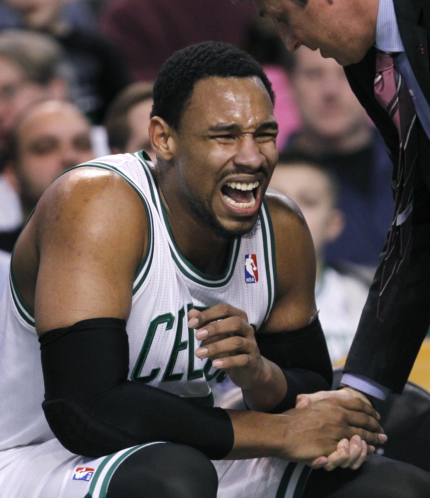 Boston Celtics center Jared Sullinger wincesafter injuring a finger during the first quarter of an NBA basketball game against the Oklahoma City Thunder in Boston, Friday, Jan. 24, 2014. Sullinger returned to play later in the quarter, with his fingers taped.