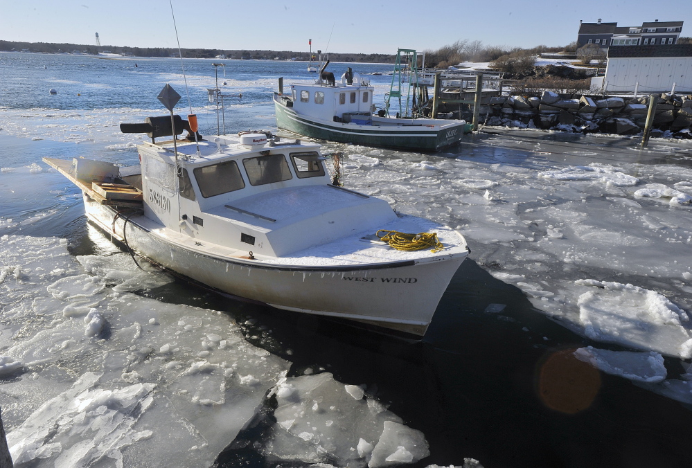 The lobster boat West Wind breaks through ice floes on its way to the fish pier at Biddeford Pool on Friday. So far, this is the coldest Maine winter since 2002-2003.