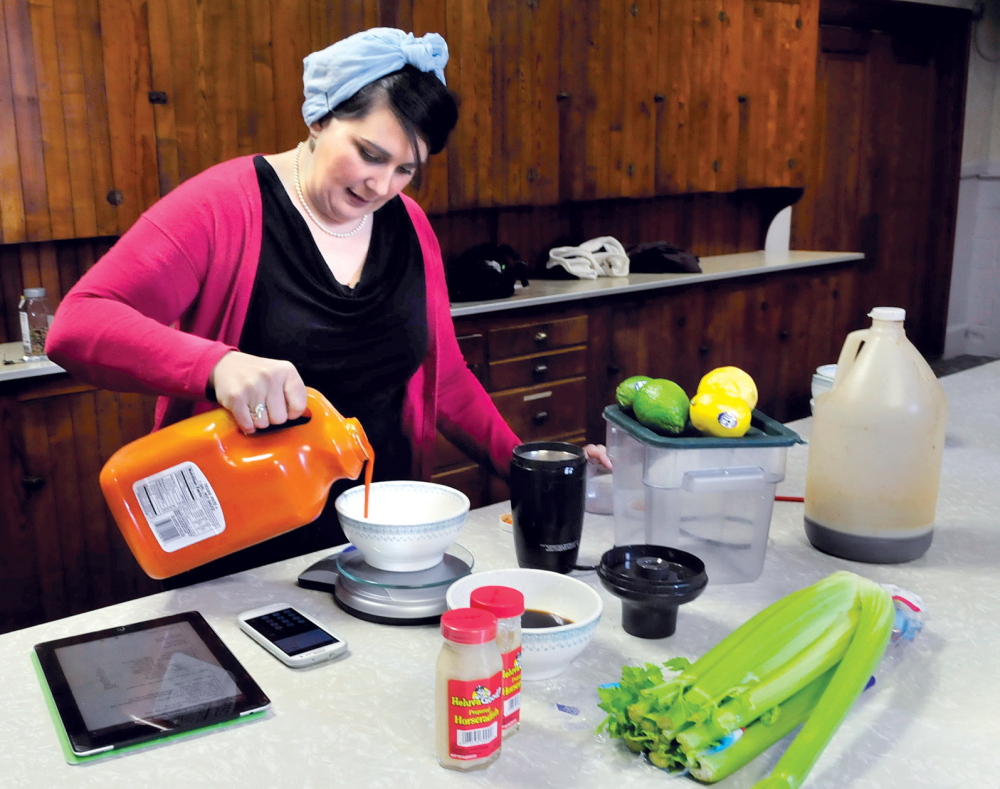 MORNING BREW: Katie Quinn mixes ingredients to her Ass Over Teakettle bloody Mary product she makes in Skowhegan on Thursday.