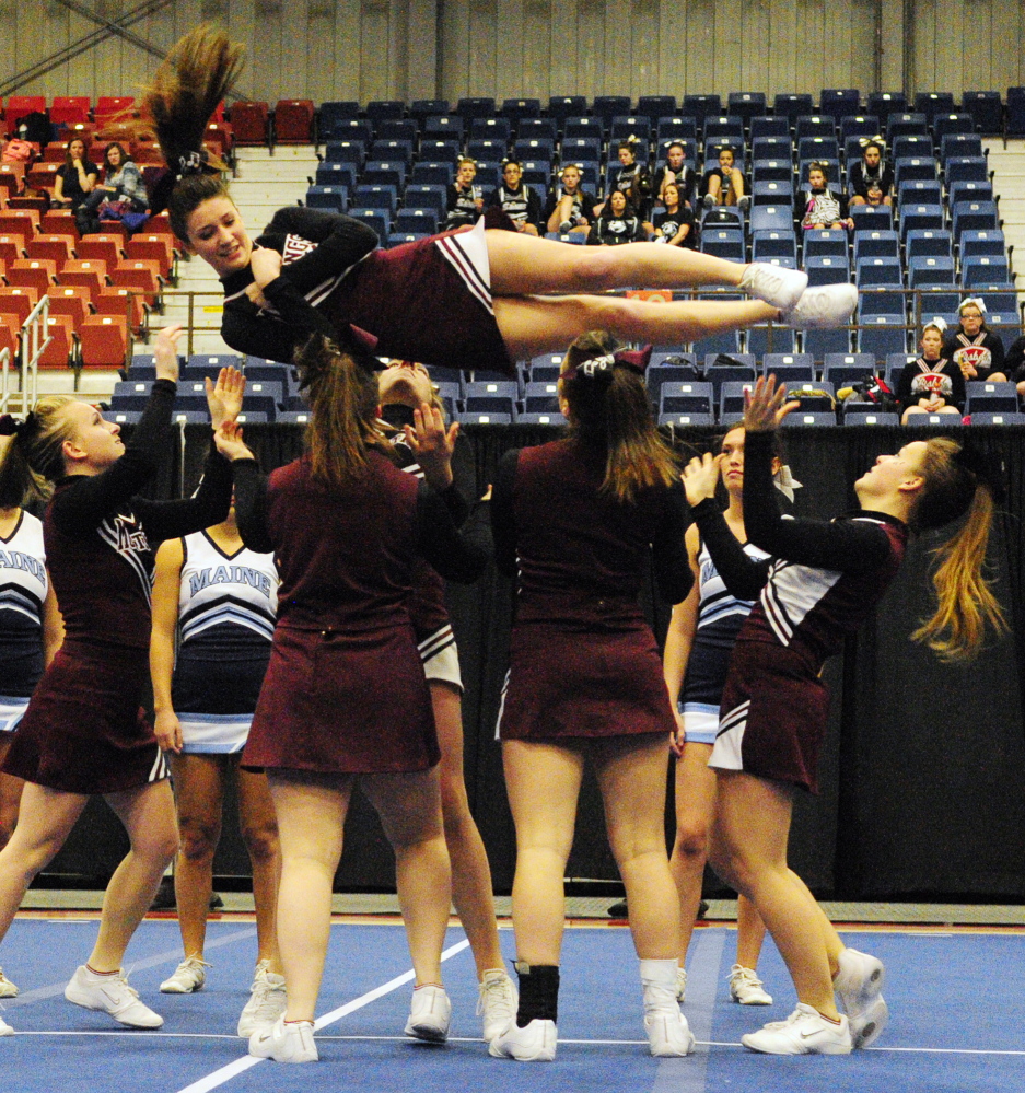 Staff photo by Joe Phelan Monmouth Academy cheerleaders spin teammate Emily Lombardo in a barrel roll as the Mustangs compete in the Class C West cheering championship on Saturday January 25, 2014 in the Augusta Civic Center. They finished fifth and qualified for state meet in two weeks in Augusta.