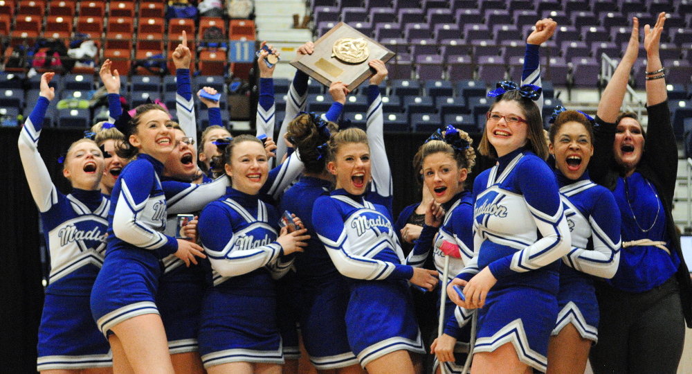 Staff photo by Joe Phelan Holding aloft their plaque, Madison cheerleaders celebrate winning the Class C West cheering championship on Saturday January 25, 2014 in the Augusta Civic Center.