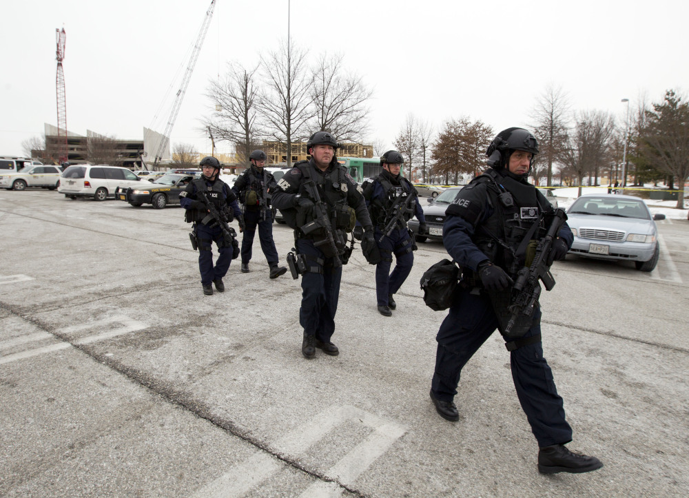 Police move in from a parking lot to the Mall in Columbia after reports of a multiple shooting on Saturday. Police in Maryland say three people died in a shooting at a mall in suburban Baltimore, including the presumed gunman.