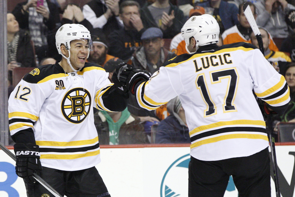 Jarome Iginla, left, celebrates his goal with Milan Lucic of the Boston Bruins in the first period Saturday against the Flyers at Philadelphia.
