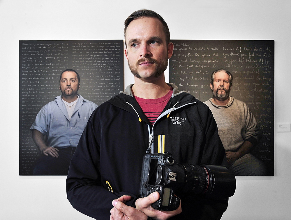 Trent Bell stands in front of portraits at the Engine gallery in Biddeford. Behind him is Wesley Knight, left, convicted of murder, and Peter Mills, convicted of gross sexual assault. Bell said the exhibit does not seek to glorify the convicts or minimize their crimes, but may offer lessons that could prevent future victims’ suffering.