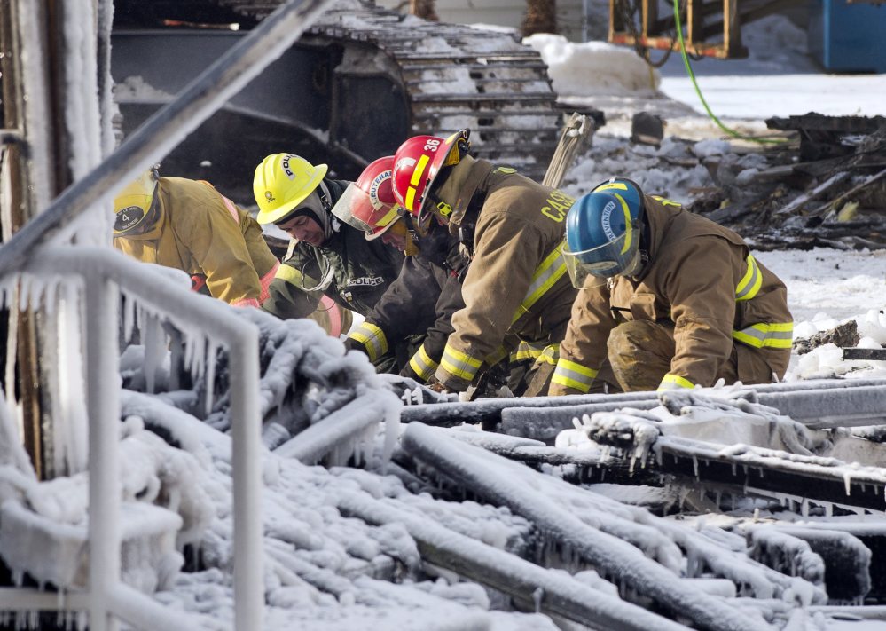 Rescue personnel search through the icy rubble of a fire that destroyed a seniors’ residence on Friday in L’Isle-Verte, Quebec. Five people are confirmed dead and 30 people are still missing, while the cause of Thursday morning’s blaze is unclear police said.