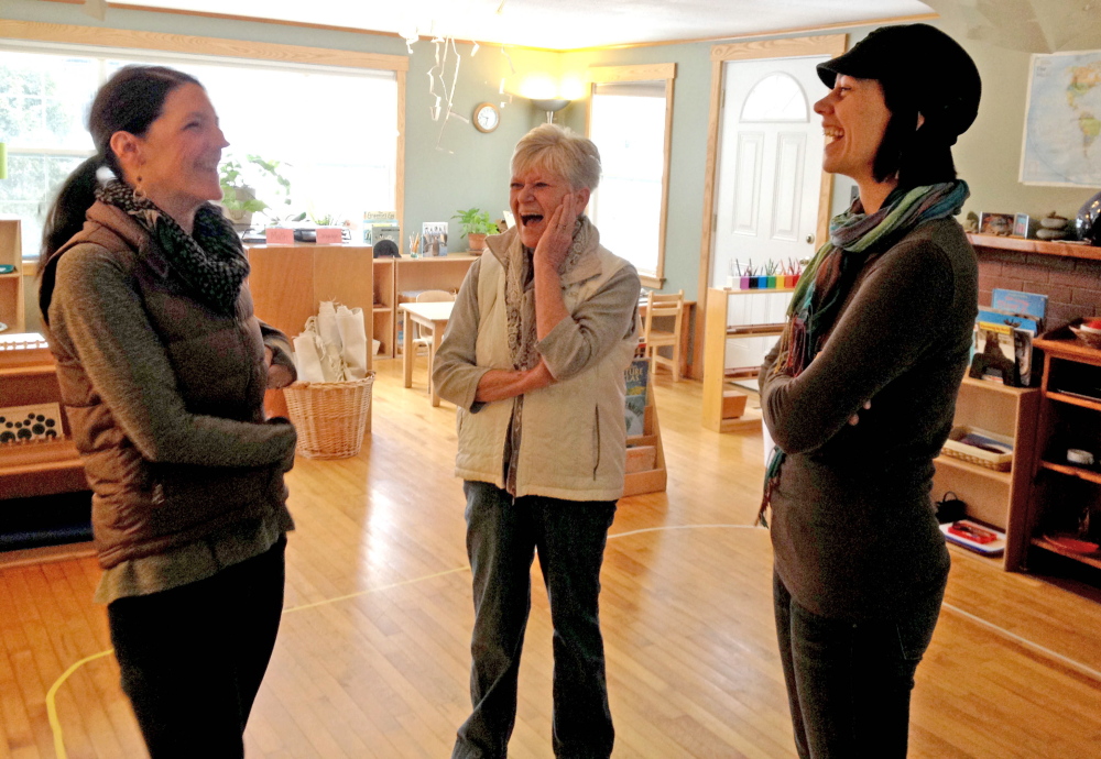 Carrying on: Bethany Mahar, from left, Kate Hatfield and Polly MacMichael laugh over good memories of Samantha Wright at the Maine Mountain Children’s House, a nonprofit Montessori preschool program in Kingfield that Wright founded. Wright was killed in a car accident Jan. 6.