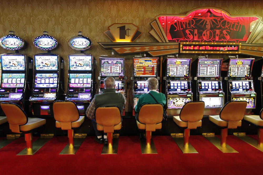 A couple play the slot machines at Hollywood Slots in Bangor. The Legislature is considering bills to expand gambling operations in Maine for the Passamaquoddy tribe, veterans organizations and other groups.