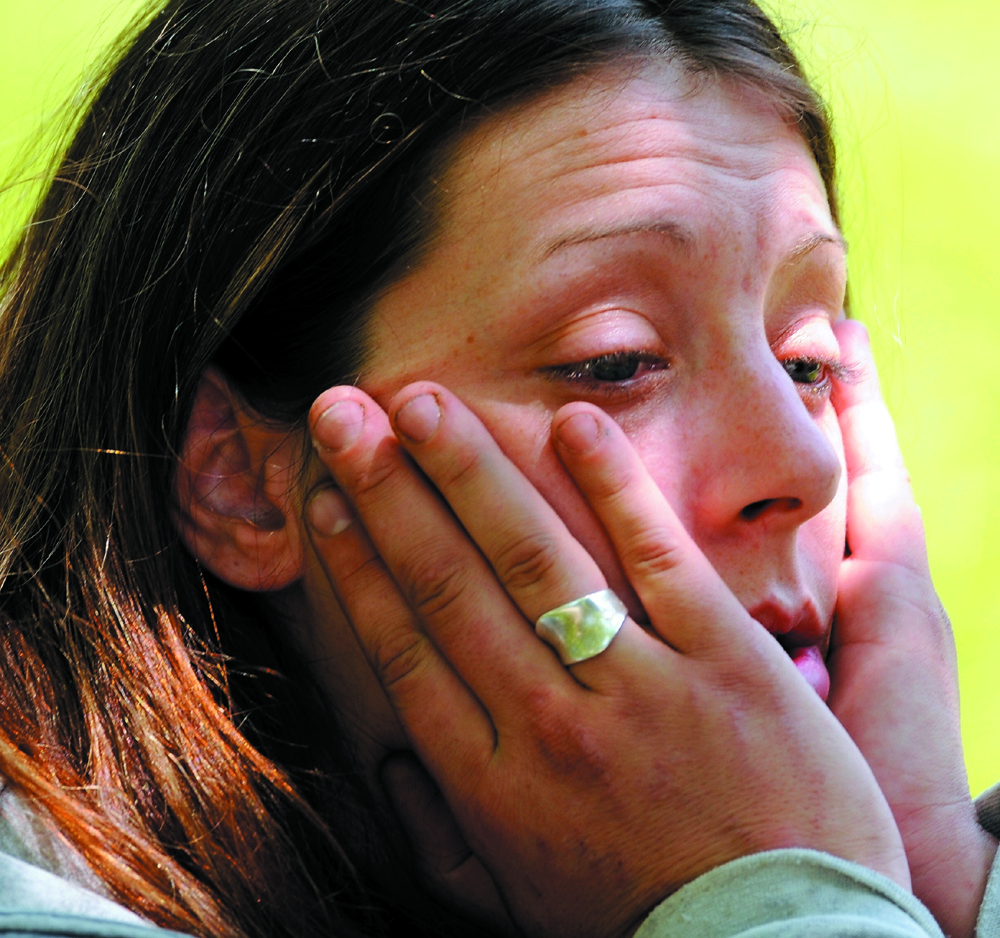 DRUG ARREST: Jennifer Dowling waits to be taken to jail in June after being arrested by Augusta police on drug possession charges after drug agents and Augusta police raided 21 Glenwood St. in Augusta.