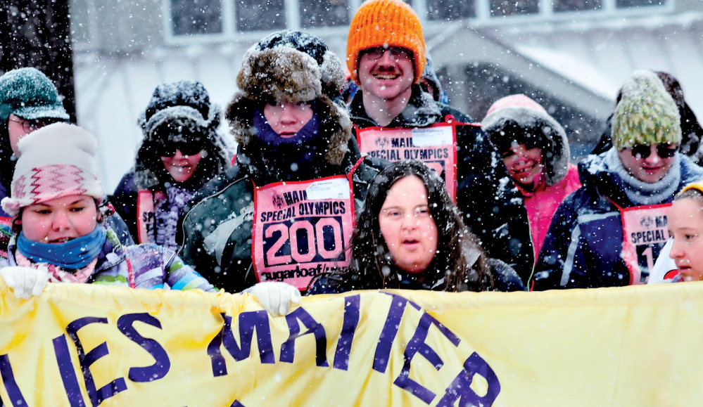 SPECIAL DAY: Caitlin Killarney, center, joined other athletes with Families Matter Inc. of Waterville during opening ceremonies of the 45th annual Special Olympics Maine Winter Games held at Sugarloaf USA on Monday, Jan. 27, 2014.