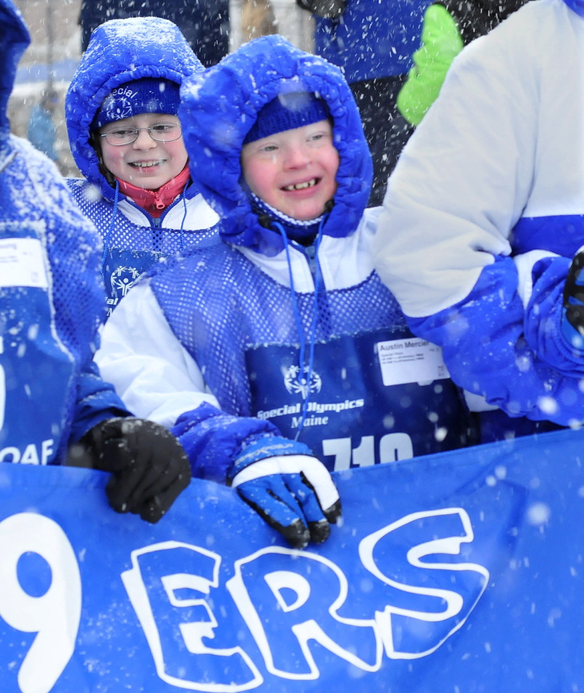 FRIENDLY COMPETITION: Austin Mercier was all smiles as he and other teammates of the Madison 59ers group march in the parade during opening ceremonies of the 45th annual Special Olympics Maine Winter Games at Sugarloaf USA on Monday, Jan. 27, 2014.