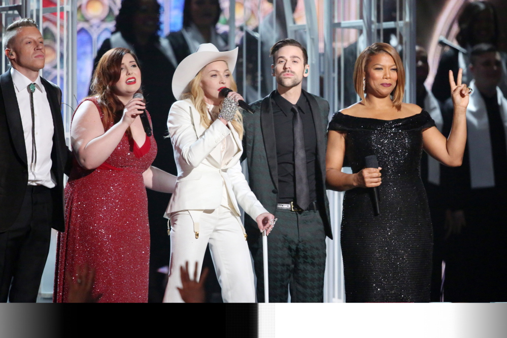 Performers, from left, Macklemore, Mary Lambert, Madonna, Ryan Lewis and Queen Latifah appear on stage during a performance of “Same Love” at the 56th annual Grammy Awards at Staples Center on Sunday in Los Angeles.