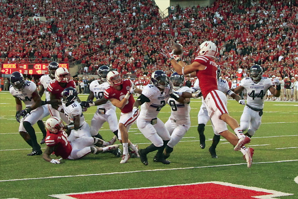 Nebraska wide receiver Jordan Westerkamp catches the game-winning touchdown over Northwestern center back Dwight White, safety Jimmy Hall and linebacker Chi Chi Ariguzo in a college football game in November. Northwestern football players are spearheading an effort to unionize college athletes.