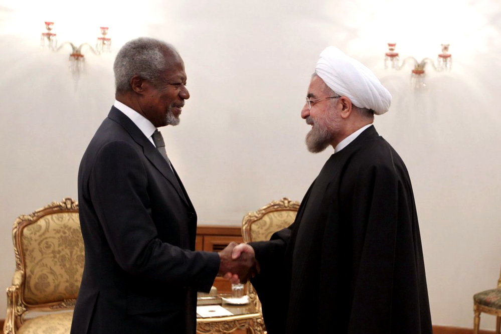 Former U.N. Secretary General Kofi Annan, left, shakes hands with Iranian President Hassan Rouhani at his office, in Tehran, Iran, on Tuesday. Iran denies it is making a bomb and says it is pursuing nuclear capabilities for peaceful purposes.