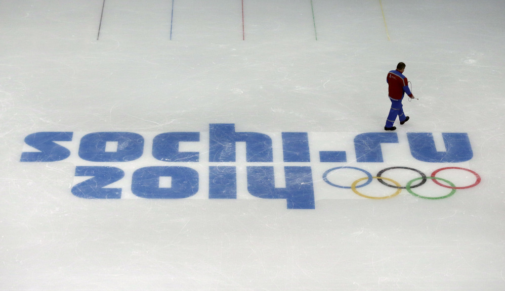 This file photo of is a worker leaves after checking ice conditions at the Iceberg Skating Palace, where the figure skating and short track speed skiing will take place, at the 2014 Winter Olympics in Sochi, Russia.