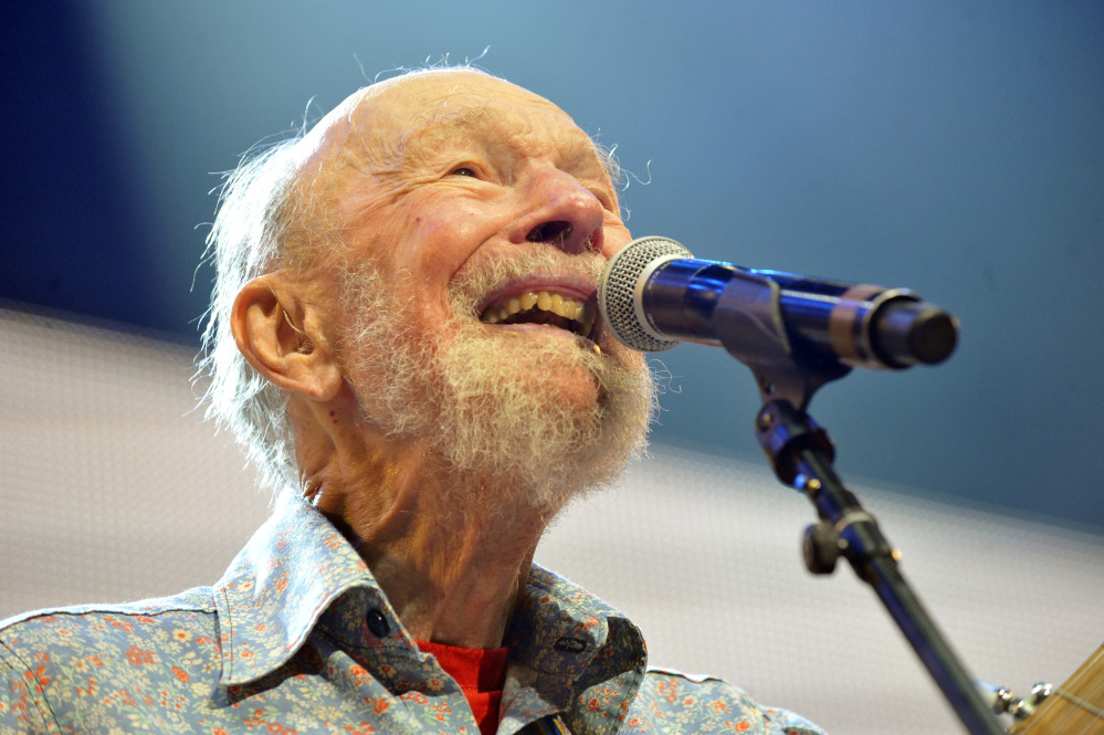In this Sept. 21, 2013, photo shows Pete Seeger performs on stage during the Farm Aid 2013 concert at Saratoga Performing Arts Center in Saratoga Springs, N.Y.