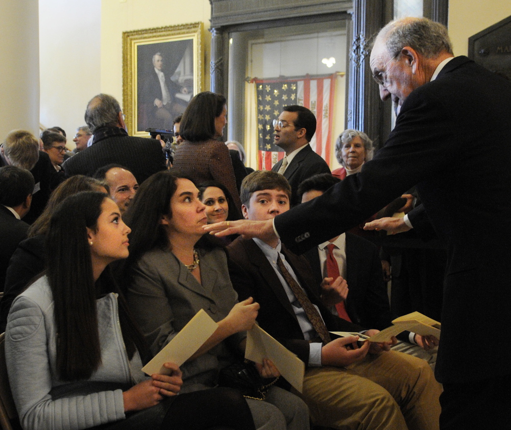 ON DISPLAY: Former US Senator George Mitchell speaks with his family Tuesday before the ceremony to unveil his official portrait at the Statehouse in Augusta. They are, seated from left, his daughter Claire, wife Heather, grandson Ian and son Andrew.