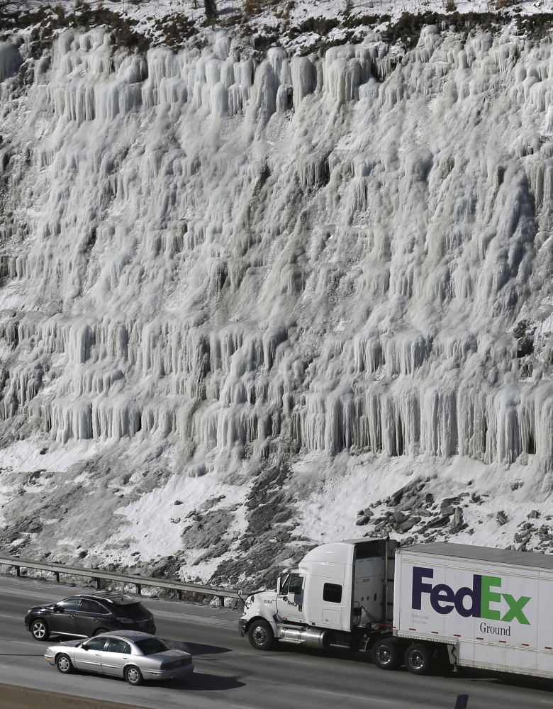 Traffic moves south on Interstate 75 past a hill covered with ice Wednesday in Covington, Ky., where temperatures remain in single digits. Temperatures will range from the teens in northern Kentucky to double-digits below zero in Minnesota, but even colder wind chills were expected: minus 43 in Minneapolis; minus 18 in Dayton, Ohio; minus 14 in Kansas City, Mo.; and minus 3 in Louisville, Ky.