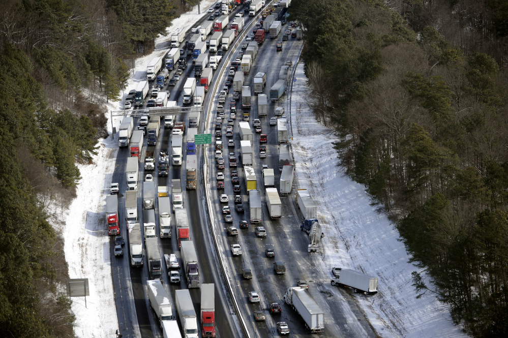 In this aerial photo, traffic is snarled along the Interstate 285 perimeter north of the metro area after a winter snowstorm Wednesday in Atlanta.