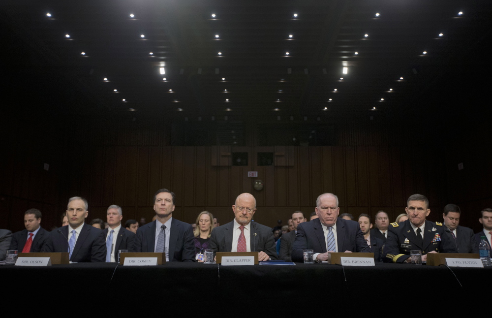 Director of National Intelligence James Clapper, center, and other security agency officials, testify on Wednesday before the Senate Intelligence Committe hearing on current and projected national security threats against the U.S. From left are, National Counterterrorism Center Director Matthew Olsen, FBI Director James Comey, CIA Director John Brennan, and Defense Intelligence Agency Director Lt. Gen. Michael Flynn.
