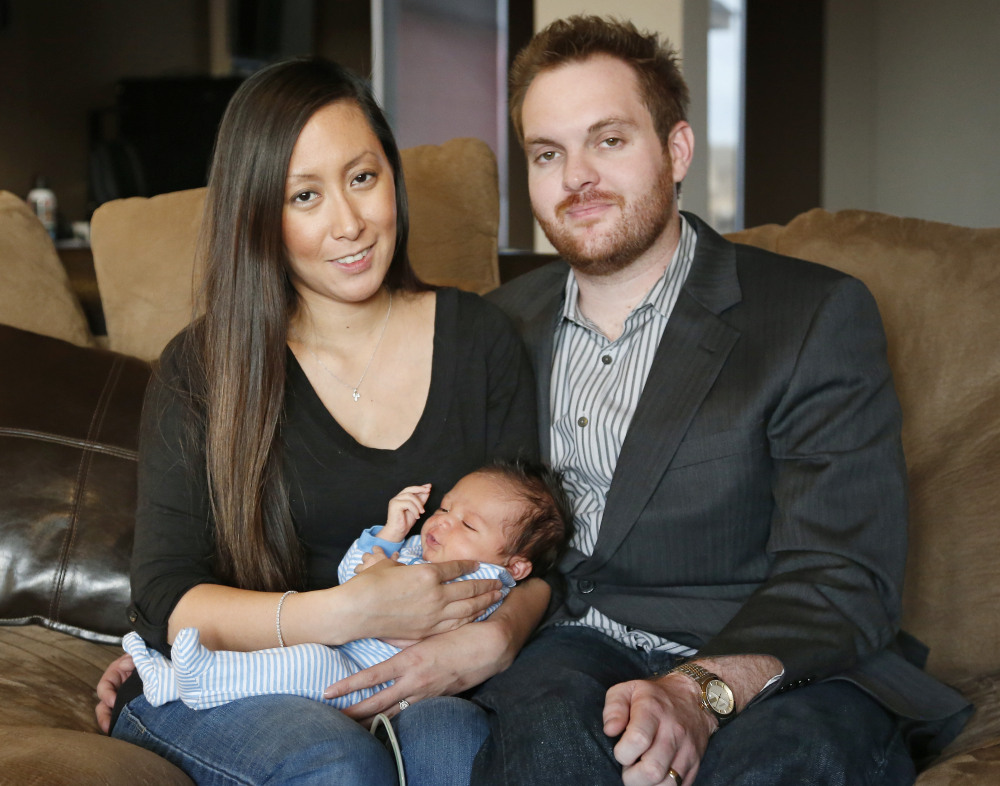 Jennifer Rogers and her husband Nyle Rogers hold Jack Nicolas Rogers in their home in Edmond, Okla., recently. Jack was born Dec. 21, 2013.