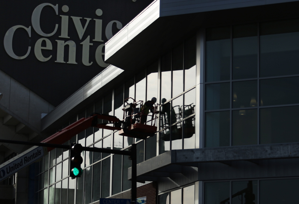 Jonni Merrill of New Hampshire Glass works on a curtain wall on the exterior of the newly renovated Cumberland County Civic Center on Spring Street in downtown Portland recently.