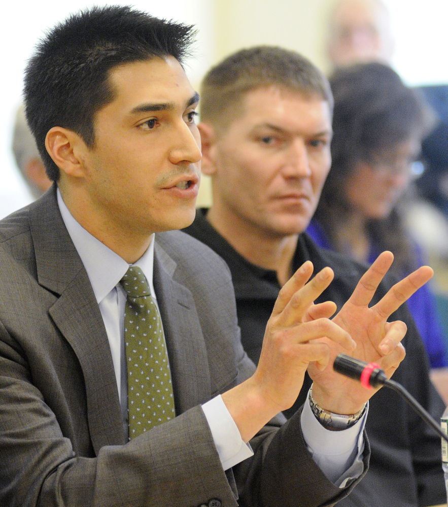 Attorney Michael-Corey Hinton addresses the Marine Resources Committee on Wednesday, Jan. 29, 2014 in Augusta on behalf of Native American elver fisherman with Passamaquoddy Vice-Chief Clayton Sockabasin in the background.