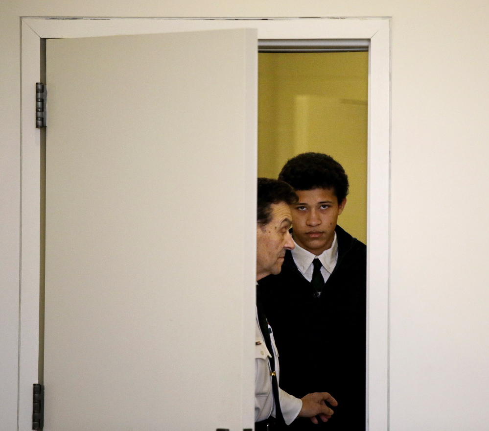 Phillip Chism, 15, from Danvers, Mass., is led into the courtroom at his arraignment on a second charge of rape in Salem Superior Court in Salem, Mass., Thursday.
