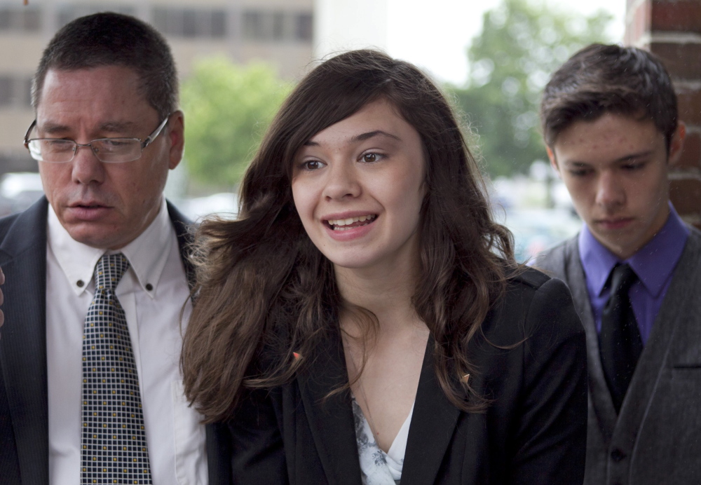 Nicole Maines, with her father Wayne Maines, left, and brother Jonas, speaks to reporters outside court in June 2013 after arguments on the Maines’ lawsuit. “I just hope (the justices) understand how important it is for students to go to school, get an education, have fun ... and not have to worry about being bullied,” Nicole said at the time.