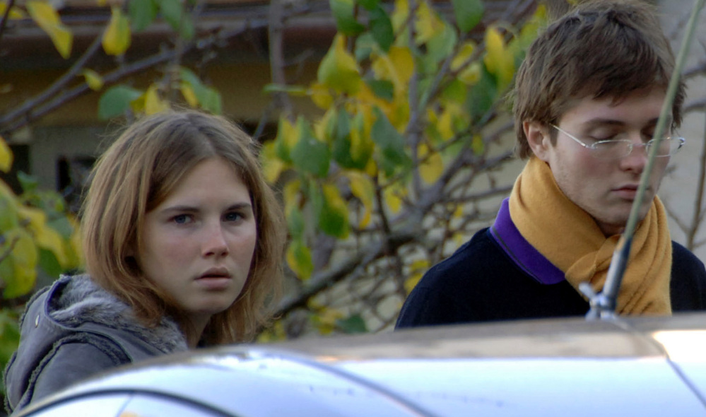 Amanda Knox and then-boyfriend Raphael Sollecito stand outside the murder scene in Perugia, Italy, in 2007.