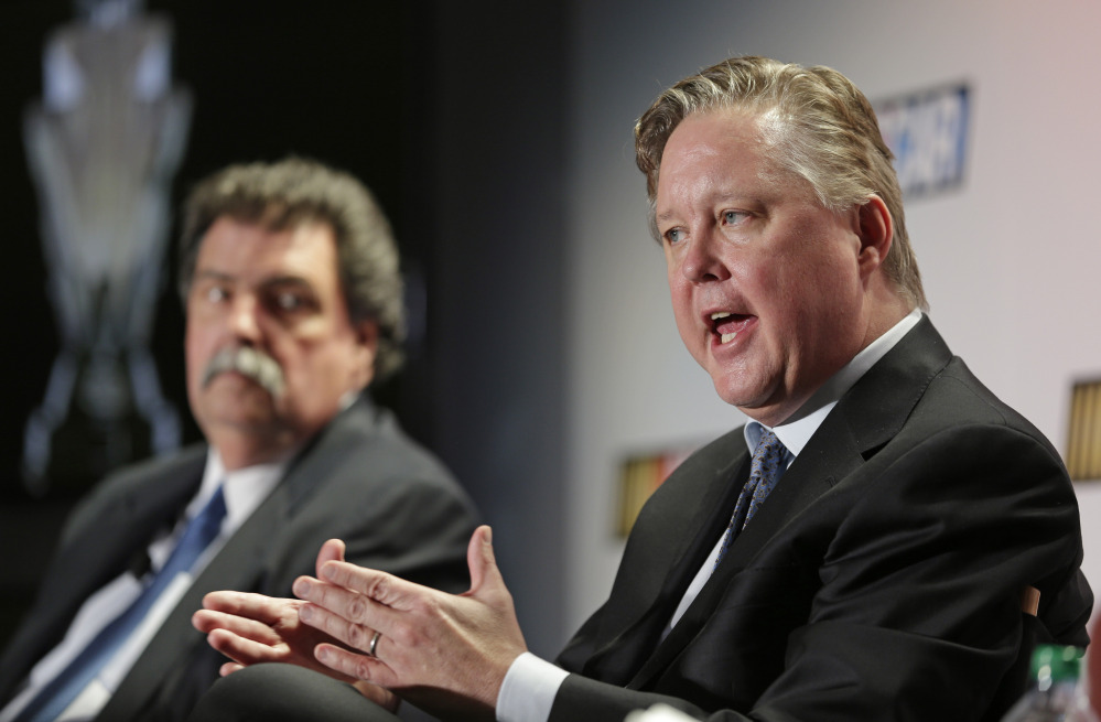 BIG CHANGE: NASCAR CEO Brian France, right, answers a question as NASCAR president Mike Helton, left, listens during a news conference at the NASCAR Sprint Cup auto racing Media Tour on Thursday in Charlotte, N.C. NASCAR will have a new, winner-take-all Chase for the Sprint Cup championship beginning this year.