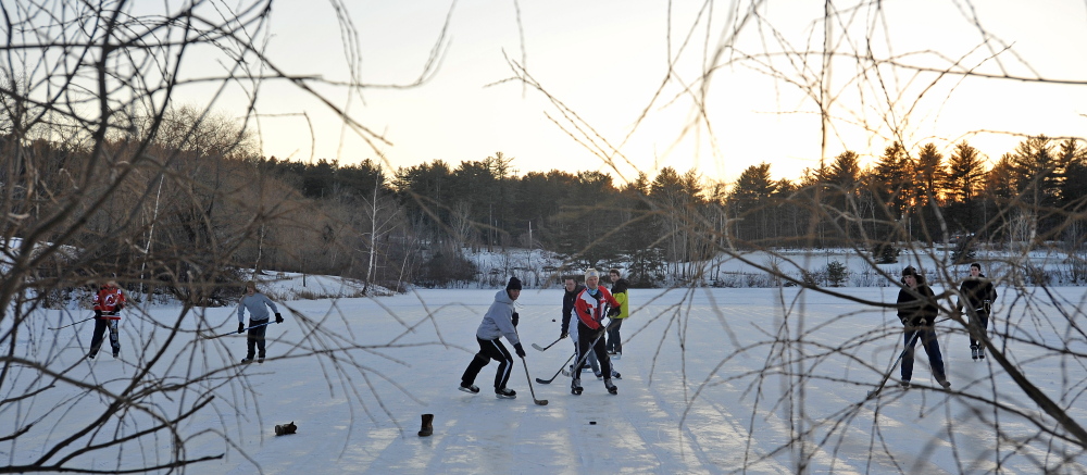 POND PUCK: People play a pick-up game of hockey on Johnson Pond at Colby College in Waterville on Wednesday, Jan. 30, 2014.