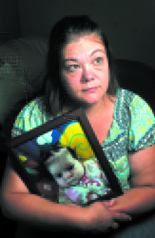 TIME OF MOURNING: Nicole Greenaway holds a picture of her daughter Brooklyn Foss-Greenaway at her home in Clinton. Her 3-month-old baby died while in the care of a friend July 8, 2012.
