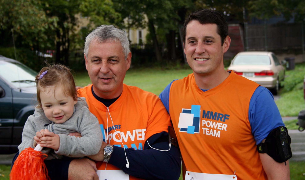 Contributed photoRUNNING TOGETHER: Michael Poulin, center, holds his granddaughter, Molly Magoun, next to his son and Molly’s uncle, Nate Poulin, at 2012’s Race for Myeloma 5K in Bangor. It was the first charity race that the Poulins ran. Nate, along with his sister and brother-in-law Katie and Andrew Magoun, would go on to raise more than $10,000 in 2013 for the Multiple Myeloma Research Foundation.