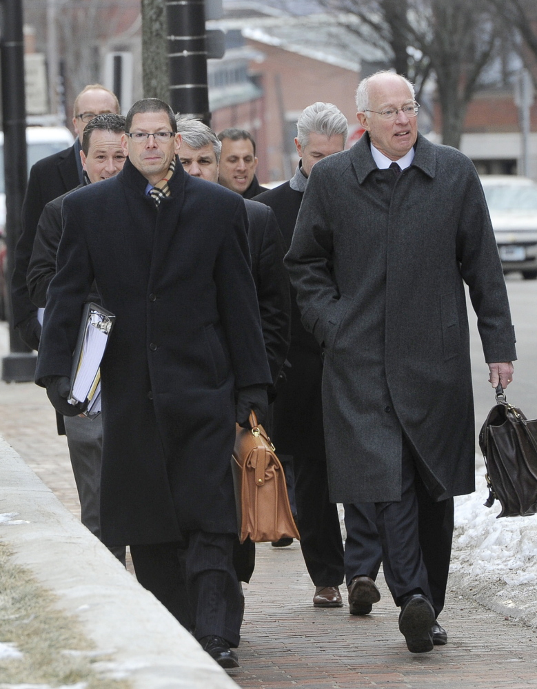 Attorney Peter DeTroy, right, who represents a petroleum transportation firm, and other lawyers walk to a federal bankruptcy hearing in Portland on Friday.