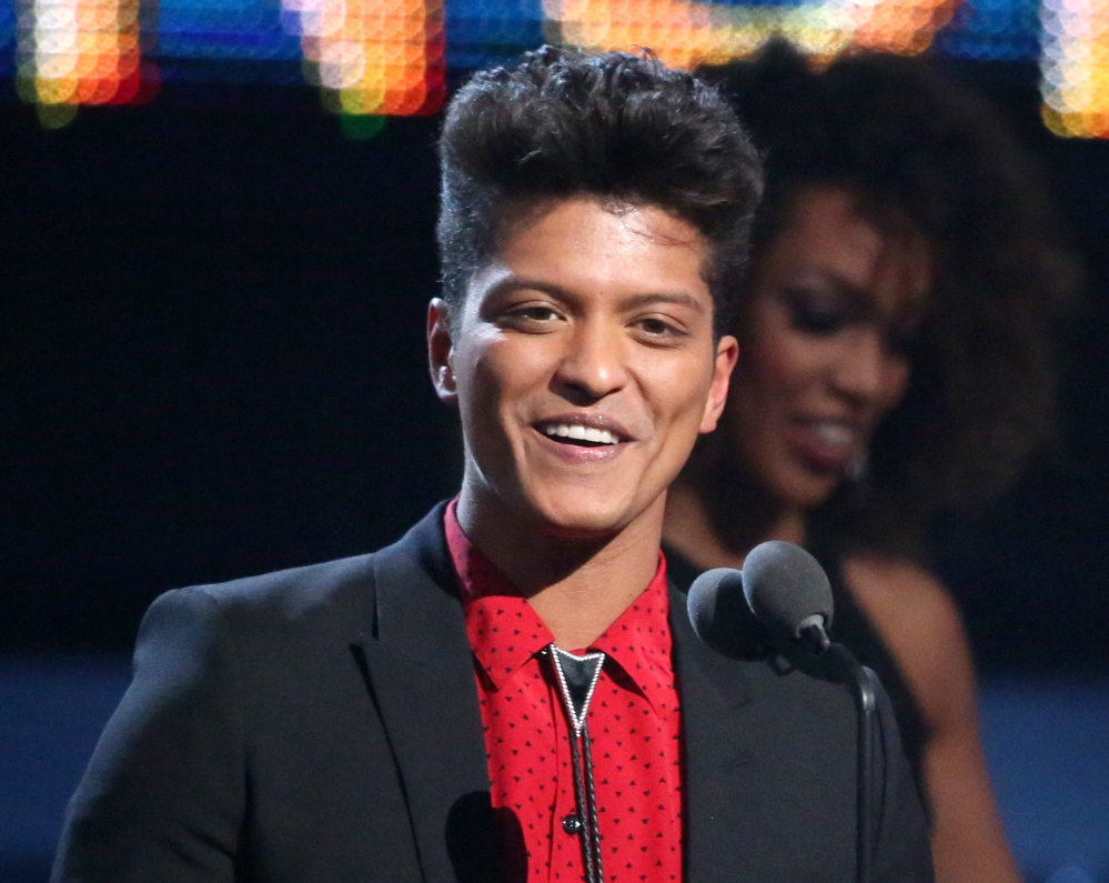 Bruno Mars accepts the award for best pop vocal album for “Unorthodox Jukebox” at the Grammy Awards in Los Angeles on Sunday. Mars will perform at the Super Bowl halftime show Sunday.